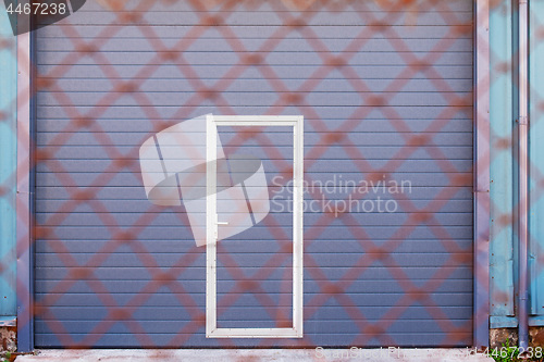 Image of Dark grey doors of industrial warehouse for vehicles.