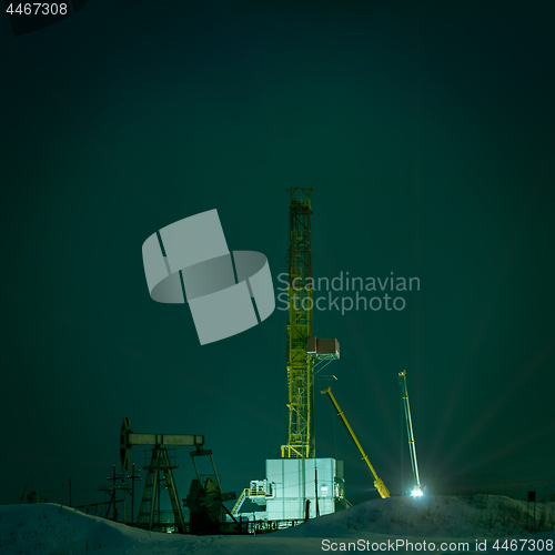 Image of Drilling rig at night.