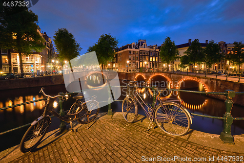 Image of Amterdam canal, bridge and medieval houses in the evening