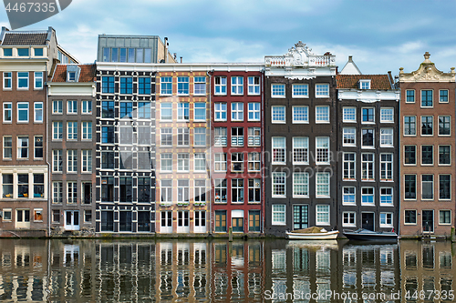 Image of Amsterdam canal Damrak with houses, Netherlands