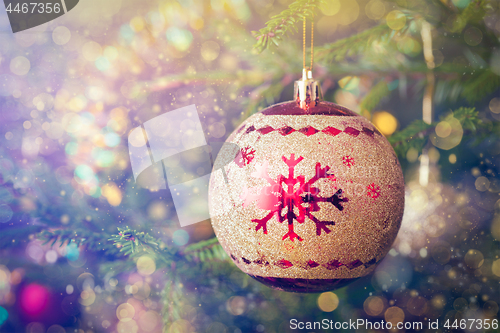 Image of Christmas-tree decoration bauble on decorated Christmas tree bac