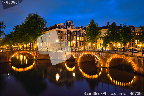 Image of Amterdam canal, bridge and medieval houses in the evening