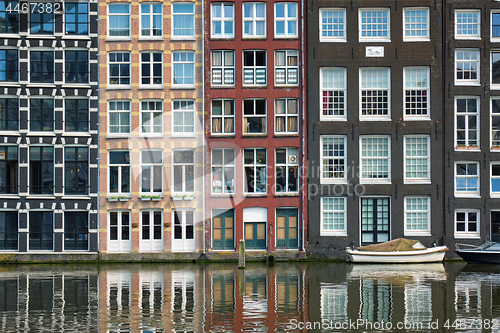 Image of Amsterdam canal Damrak with houses, Netherlands