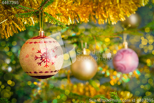 Image of Christmas-tree decoration bauble on decorated Christmas tree bac