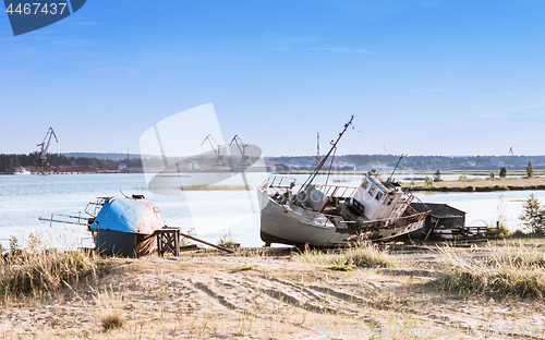 Image of Old Abandoned Ships On The Riverbank Against A River Port 