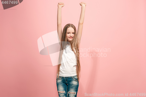 Image of Happy success teen girl celebrating being a winner. Dynamic energetic image of female model