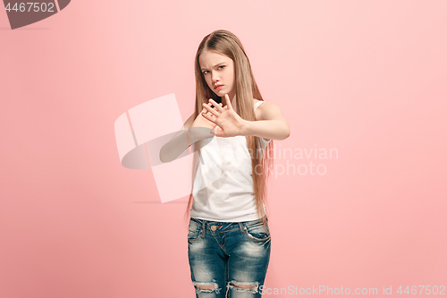 Image of Doubtful pensive teen girl rejecting something against pink background