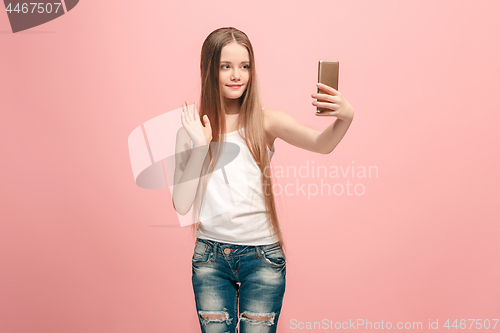 Image of The happy teen girl making selfie photo by mobile phone