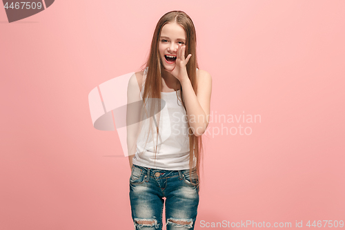 Image of young casual teen girl shouting at studio