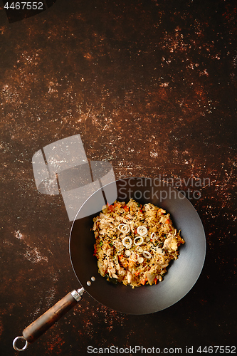 Image of Traditional orginal fried spicy rice with chicken served in a round iron wok