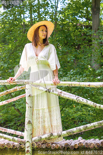 Image of beautiful woman in summer hat and white dress