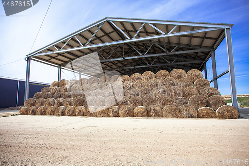 Image of sloping hay under a canopy. 