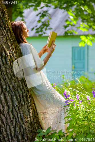 Image of beautiful woman reading a book