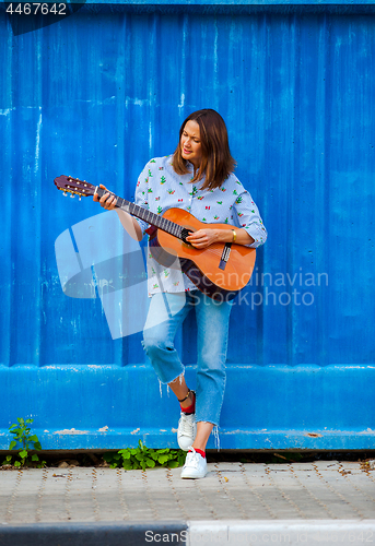 Image of Beautiful middle aged woman with a guitar
