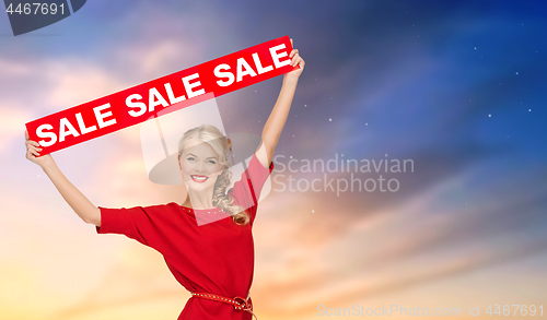 Image of woman in dress with red sale sign