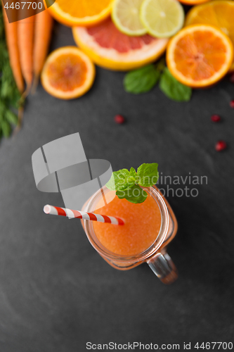 Image of mason jar glass of fruit juice on slate table top