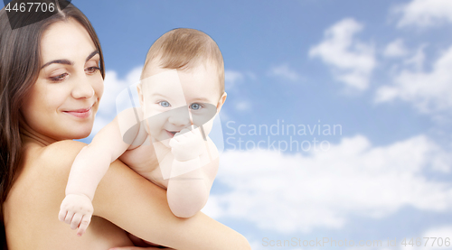 Image of mother with baby over sky background