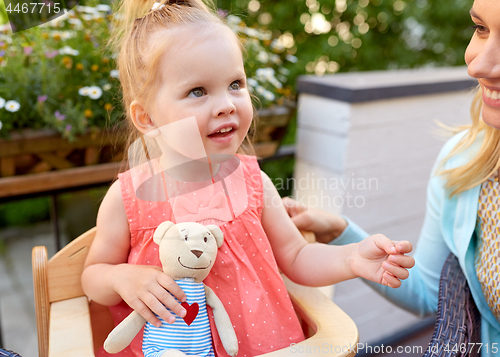 Image of portrait of happy beautiful little girl outdoors