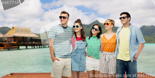 Image of friends in sunglasses over bora bora background