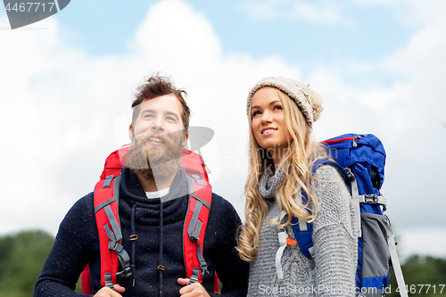 Image of couple of travelers with backpacks hiking