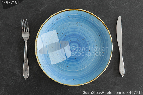 Image of close up of plate, fork and knife on table