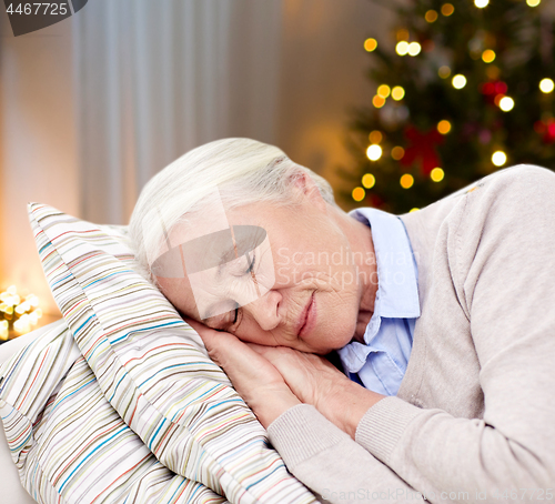 Image of senior woman sleeping on pillow on christmas