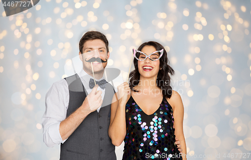 Image of happy couple with party props having fun