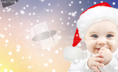 Image of little baby boy in santa hat on christmas
