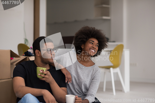 Image of African American couple relaxing in new house