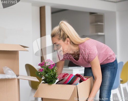 Image of girl moving in the new apartment