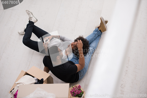 Image of African American couple relaxing in new house