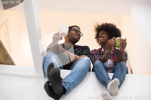 Image of couple having break during moving to new house