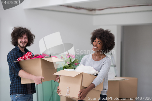 Image of multiethnic couple moving into a new home