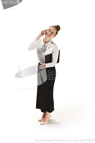 Image of Full length portrait of a smiling female teacher holding a folder isolated against white background