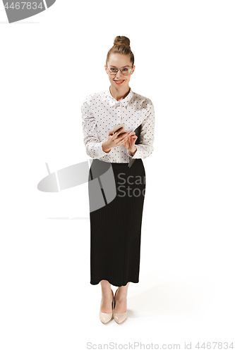 Image of Full length portrait of a smiling female teacher holding a folder isolated against white background