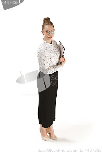 Image of Full length portrait of a smiling female teacher holding a folder isolated against white background