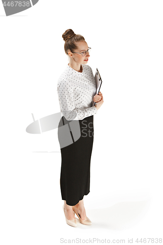 Image of Full length portrait of a smiling female teacher holding a folder isolated against white background