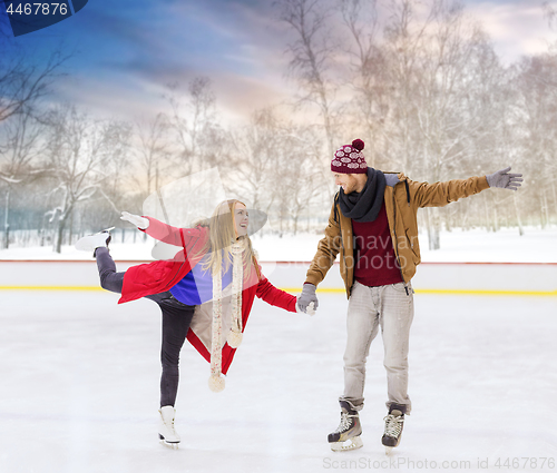 Image of happy couple holding hands on outdoor skating rink