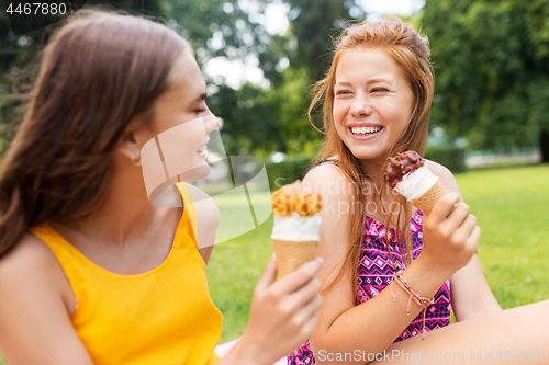 Image of teenage girls eating ice cream at picnic in park