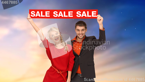 Image of couple with red sale sign