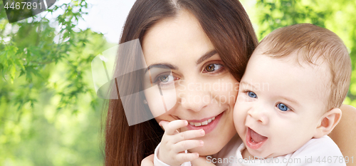 Image of mother with baby over green natural background