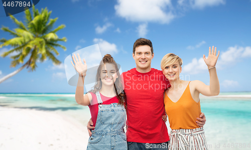 Image of happy friends hugging over beach background