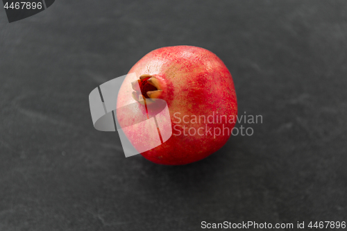 Image of close up of pomegranate on stone table