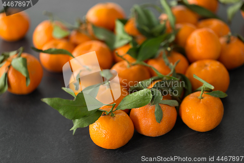 Image of close up of mandarins on slate table top