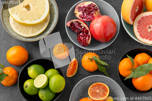 Image of close up of citrus in bowls fruits on stone table