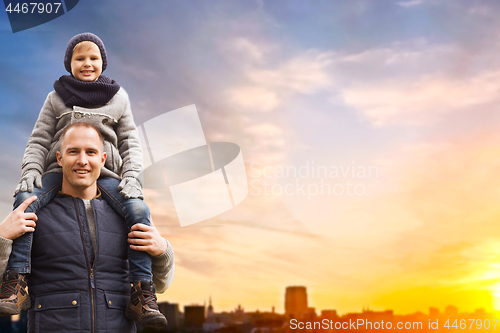 Image of happy father and son over sunset in tallinn city