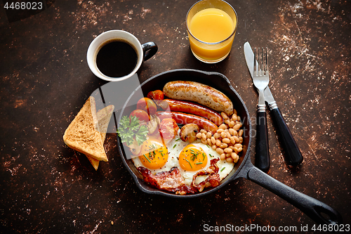 Image of Delicious english breakfast in iron cooking pan