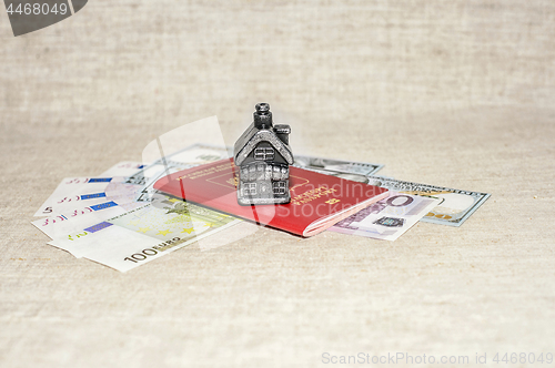 Image of Passport, money and home - the concept of buying a property