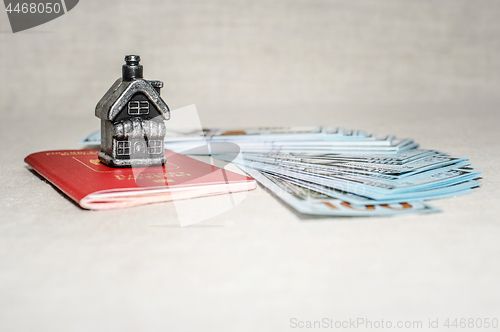 Image of Passport, money and home - the concept of buying a property