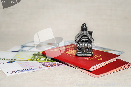 Image of Passport, money and home - the concept of buying a property